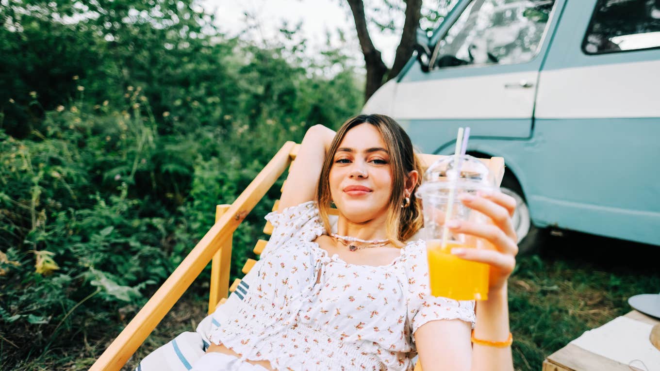Signs Someone In Your Life Is Deeply Happy, According To Psychology Deeply happy woman enjoying nature and slow lifestyle.