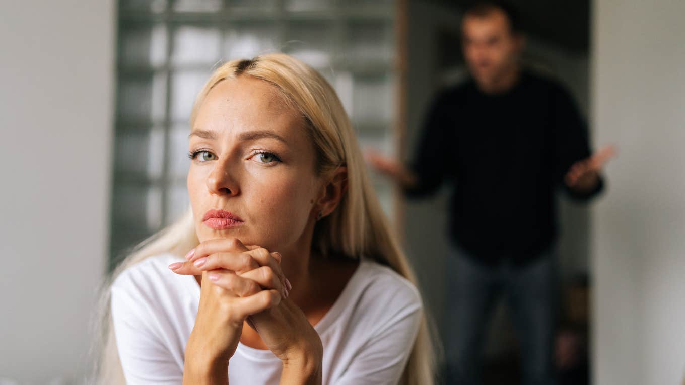 Signs A Woman Will Be A Nightmare To Divorce woman thinking with man in the background