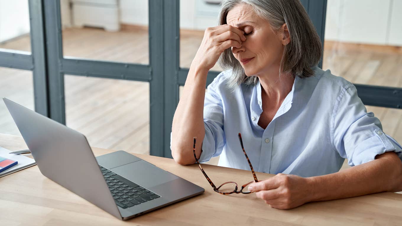 Son Admits Watching His Boomer Mom Struggle To Find A Job Is 'Cathartic' frustrated older woman sitting in front of laptop