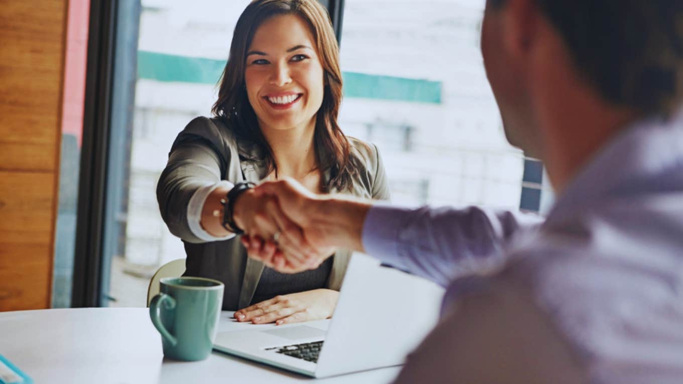 Woman Explains The Odd Way She Increased Her Salary By $100K In 3 Years woman in office shaking hands with man