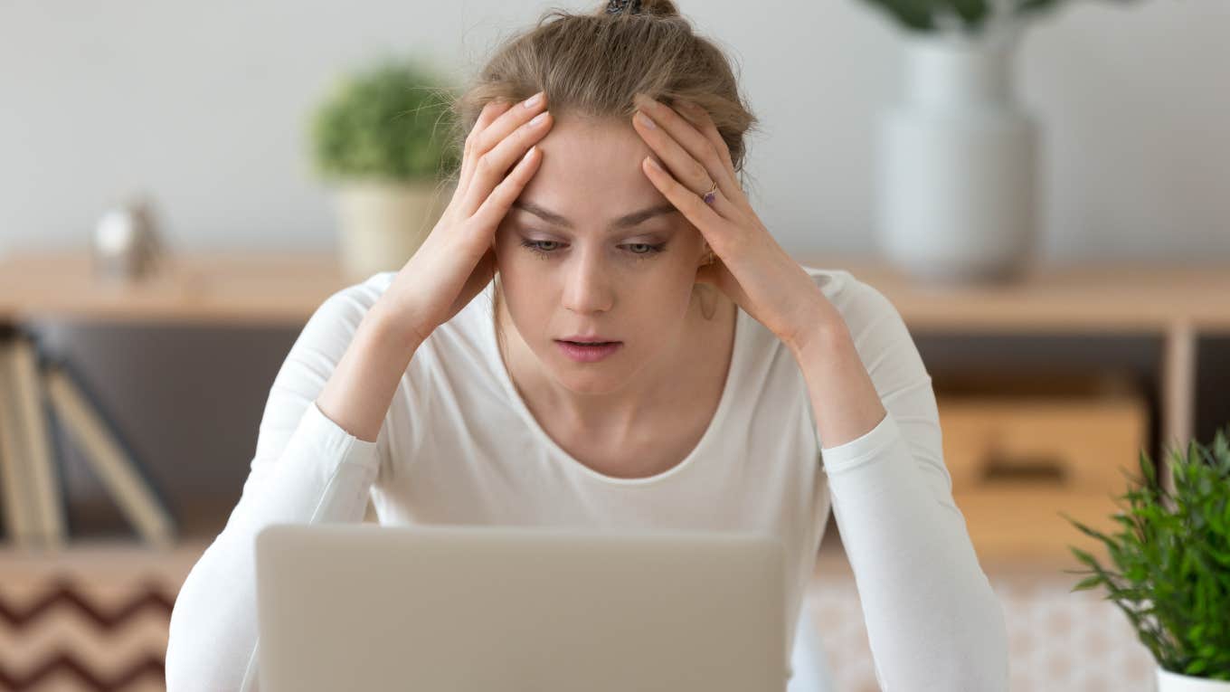 Woman Ghosted By Company After Months-Long Interview Process frustrated woman with hands on her forehead looking at laptop