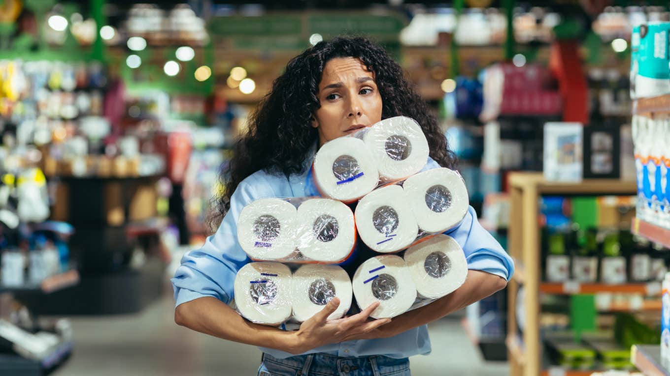 Woman Urges Americans To Be Educated As People Start Panic Buying Toilet Paper Again panicked woman holding toilet paper in supermarket