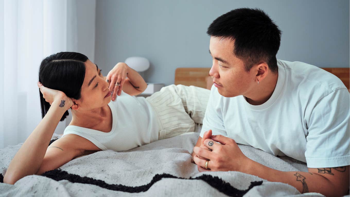 Psychology Says Couples Who Do These Things Right Before Bed Have The Deepest Bond Couple having a intimate conversation before bed.