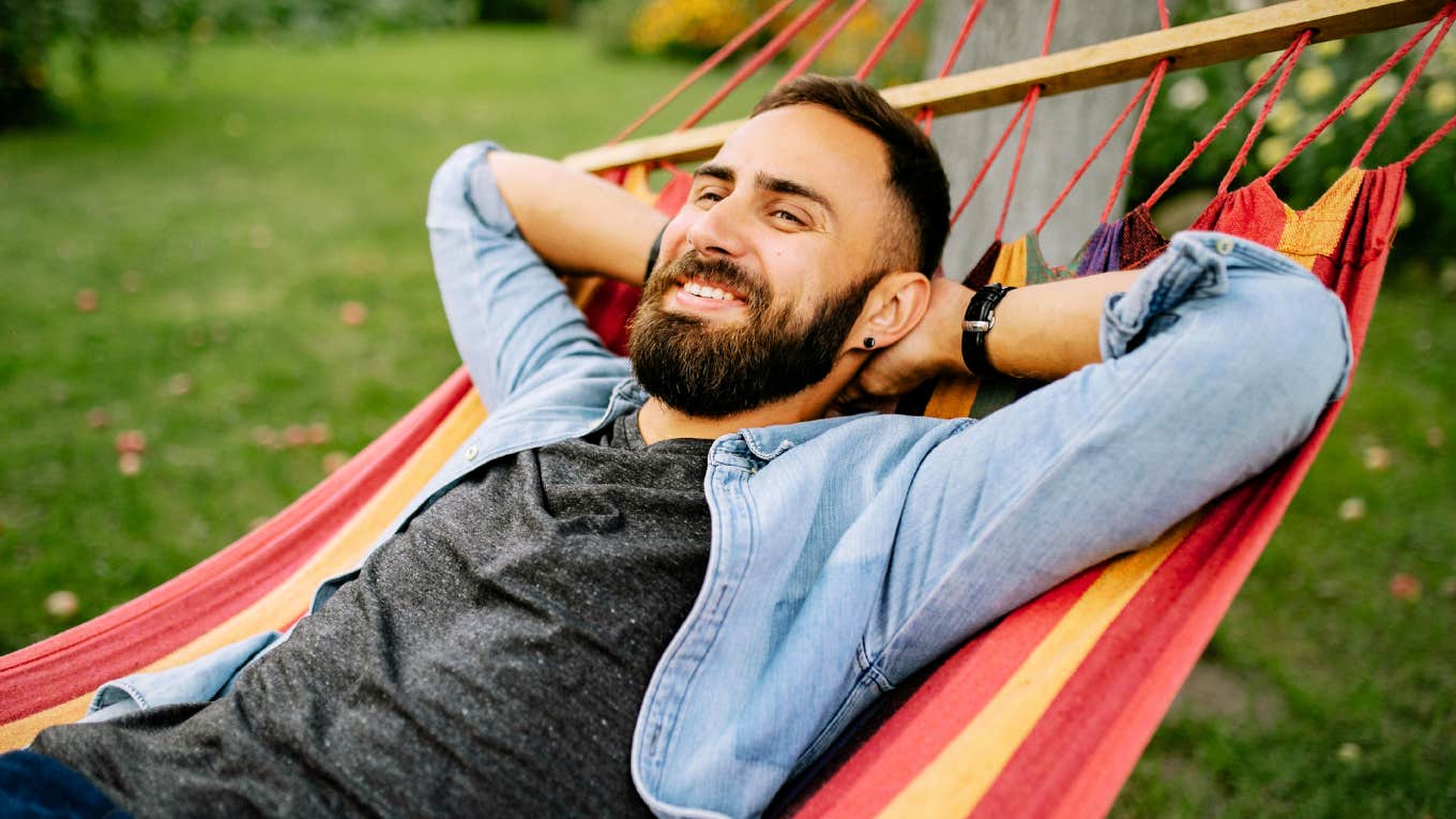 Daily Habits Of People With High IQ Man with high IQ, lounging in hammock.