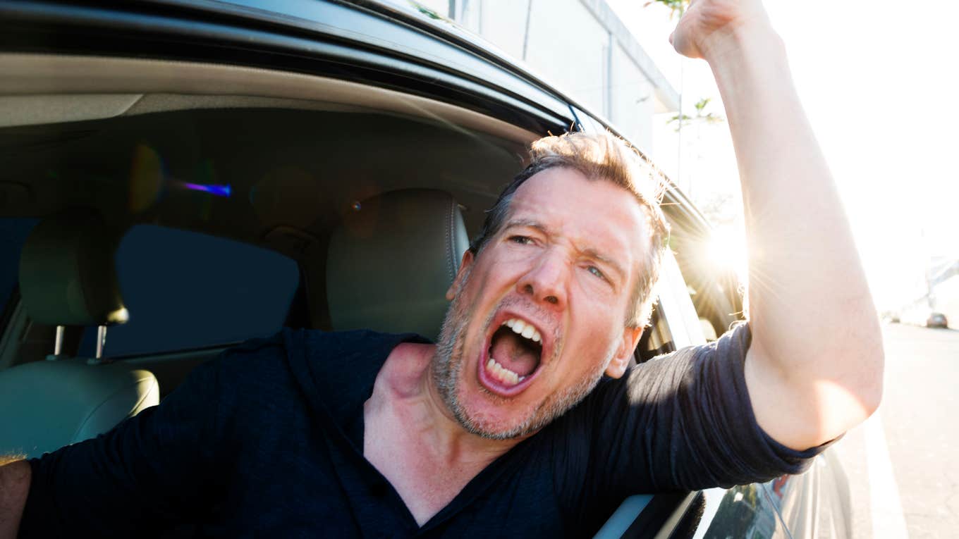 Everyday Situations That Make People More Likely To Be Rude Tired man acting rude while sitting in traffic his way home.