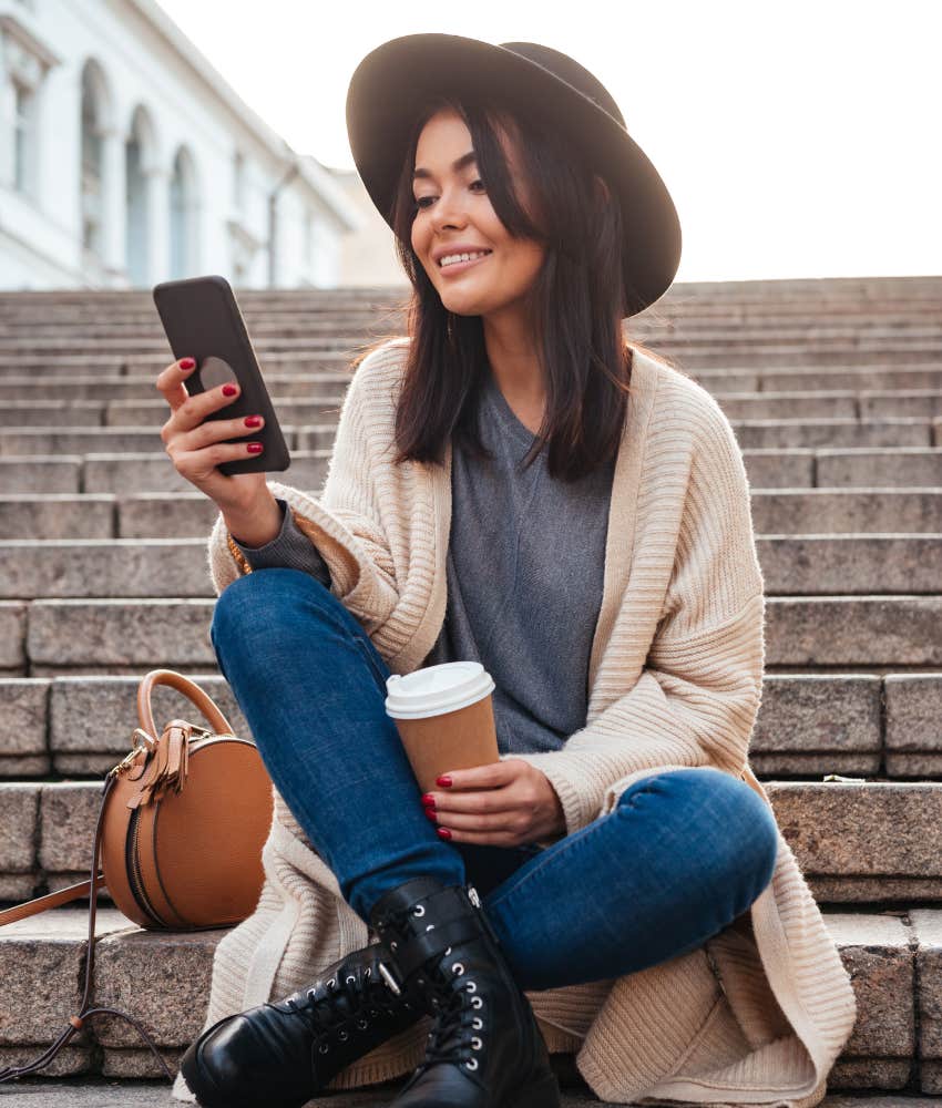 woman drinking coffee and texting