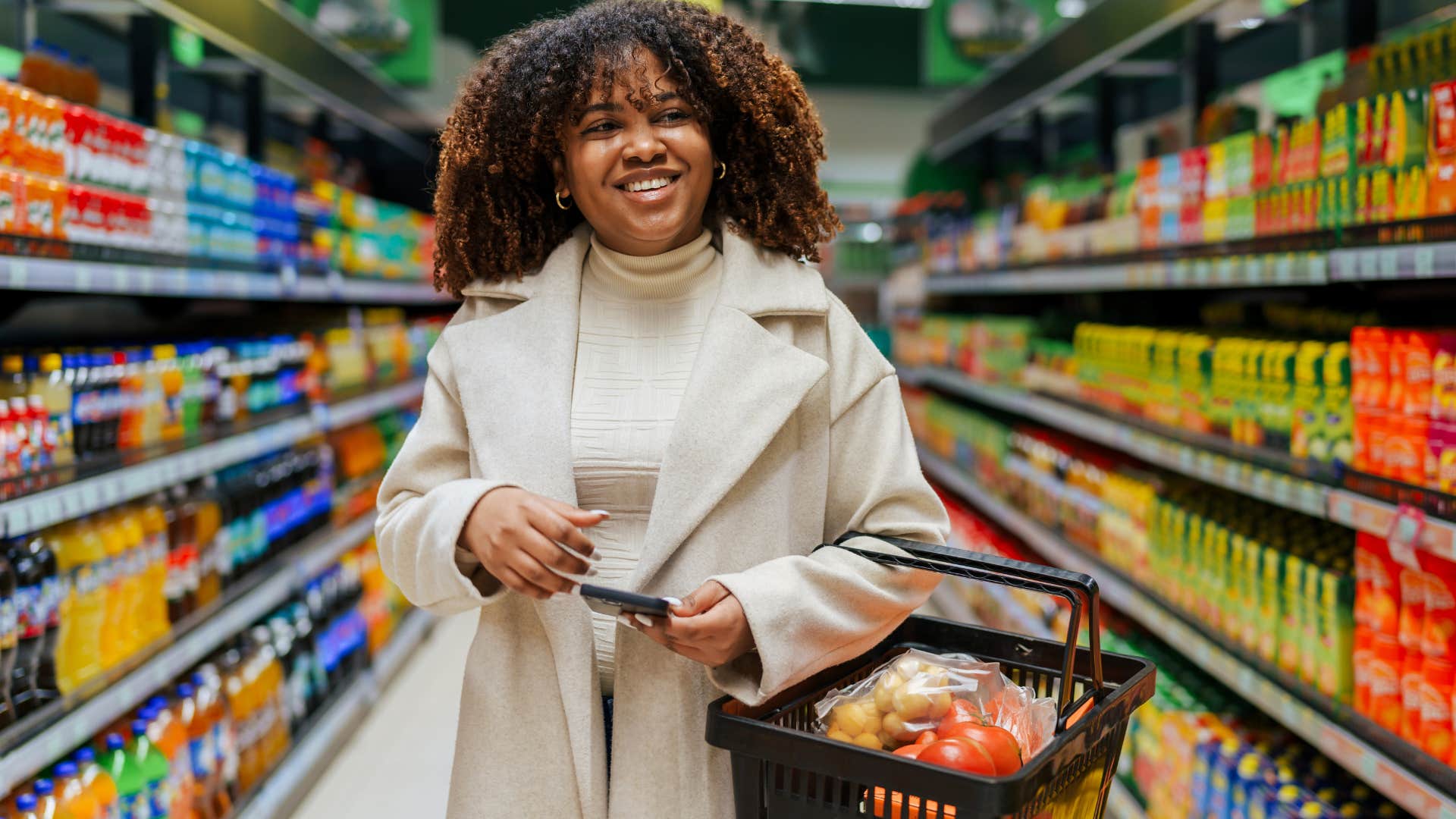Gen Z woman smiling in the grocery store.