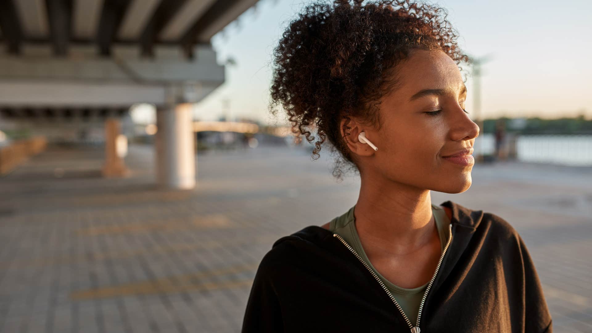 Young woman smiling outside.