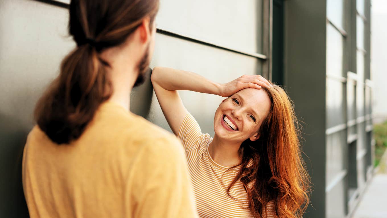 Psychology Says If You Can Master These Body Language Tricks, You'll Get The Guy Woman using flirty body language to speak to man