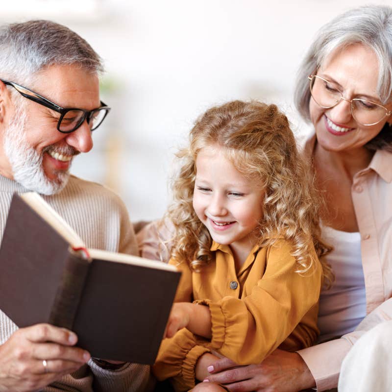 grandparents reading to granddaughter