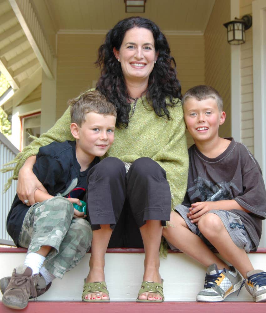 mom sitting with two young sons