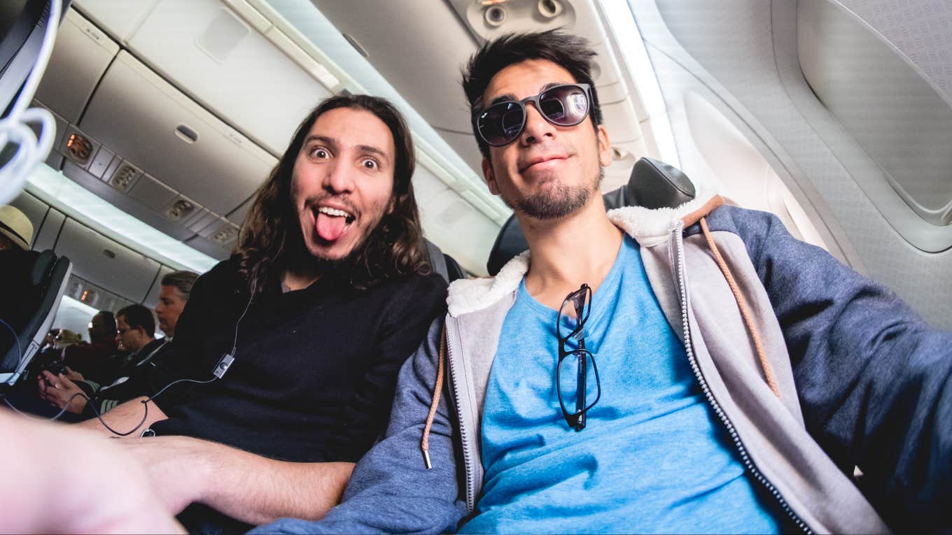 Phrases People With Bad Social Skills Use Without Realizing Two happy guys inside a flight on a plane