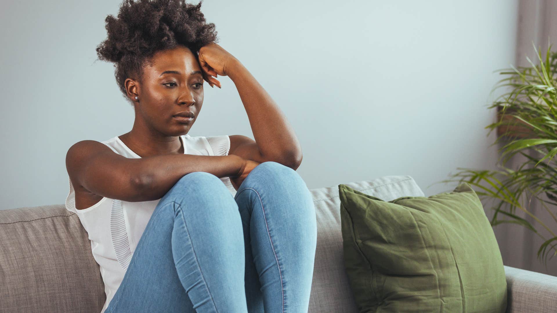 Woman looking frustrated on the couch.