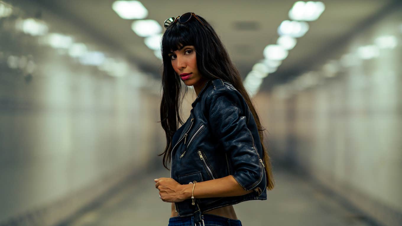 Psychology Says If You Keep Ignoring These Signs, You're Never Going To Find The One Portrait of Fashionable woman in stylish clothing walking down cross street tunnel