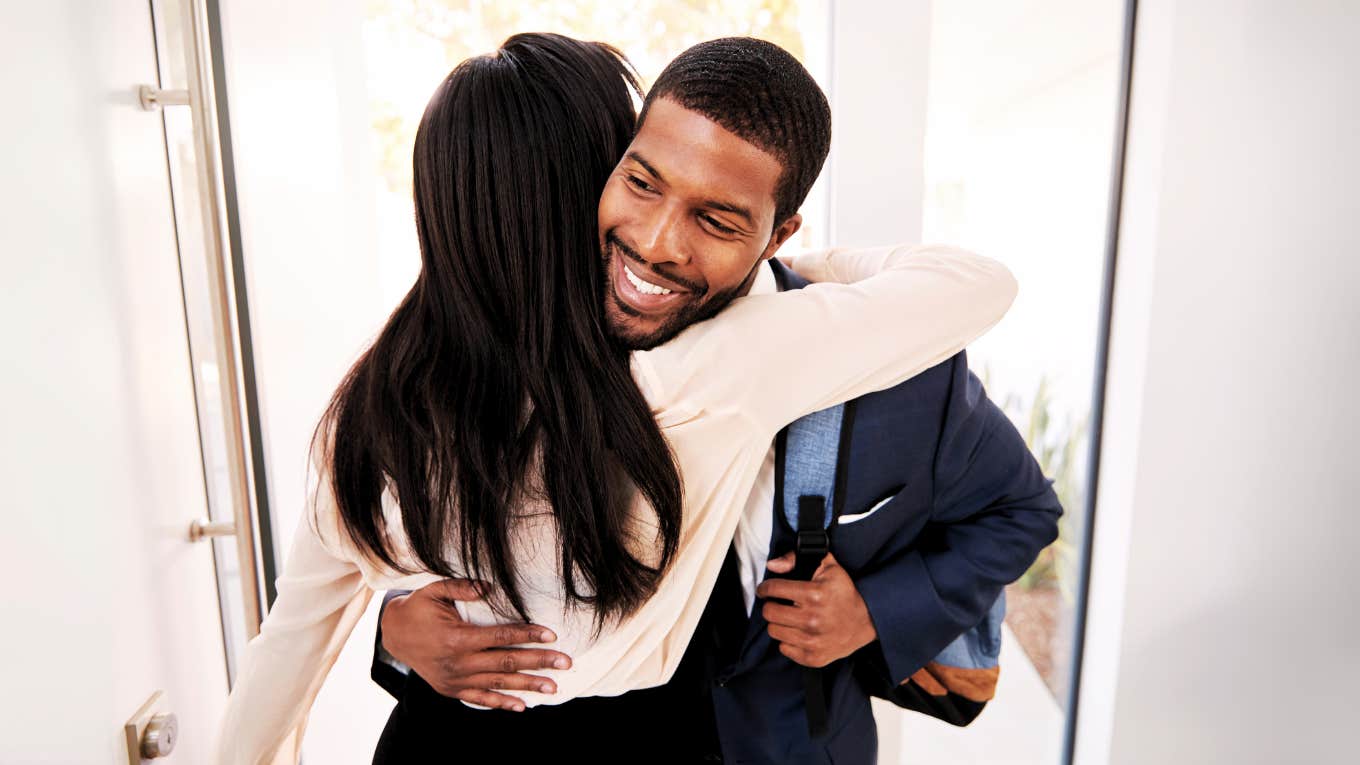 The Real Reason Married Men Earn More Than Everyone Else, According To Research Married man coming home to his wife.