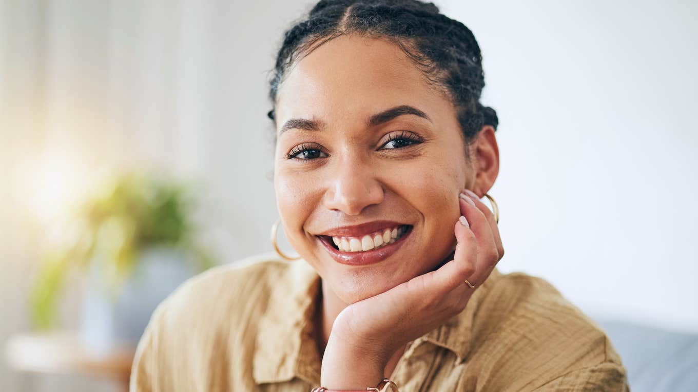 Reasons So Many Wives Are Happier When Their Husbands Aren't Around, According To Psychology smiling happy woman wearing a watch