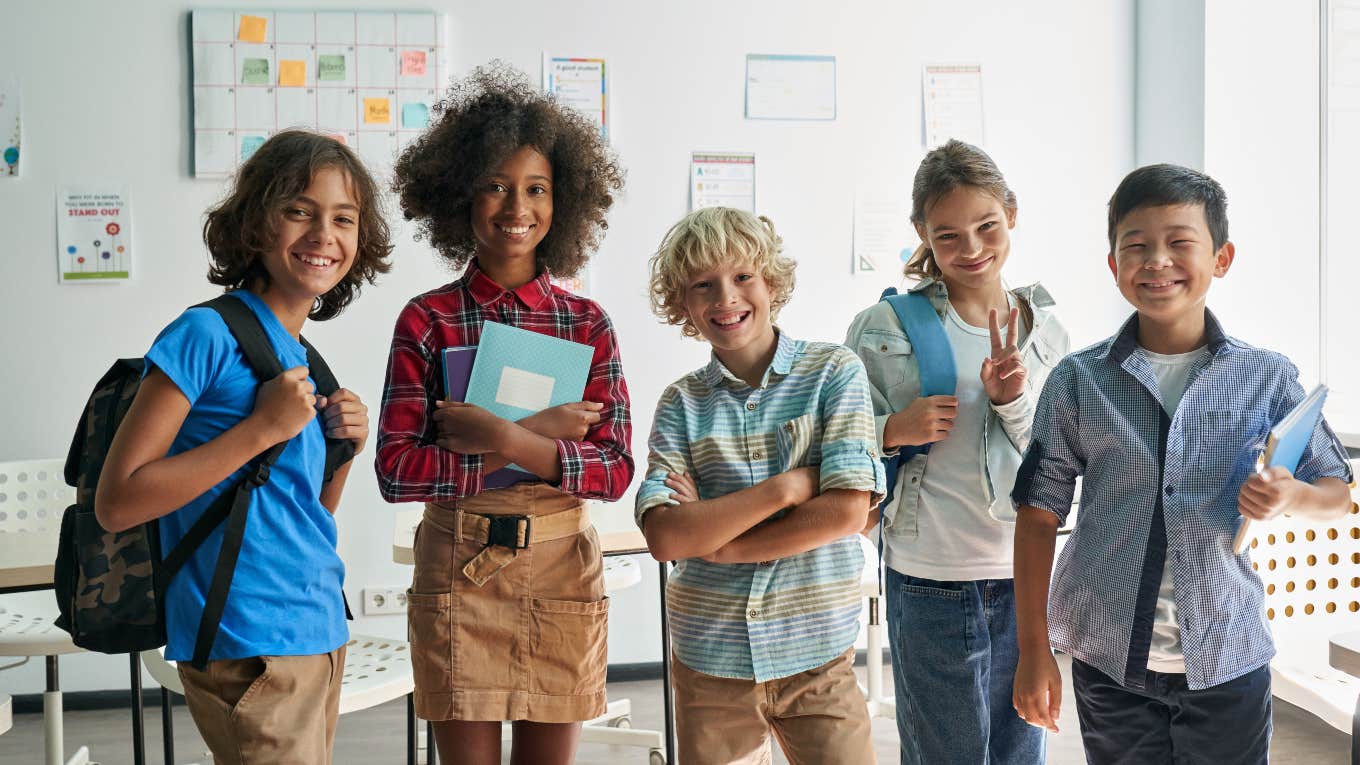 School Emails Parents To Tell Them Constable's Firearm 'Accidentally Discharged' group of middle schoolers standing in front of a white board