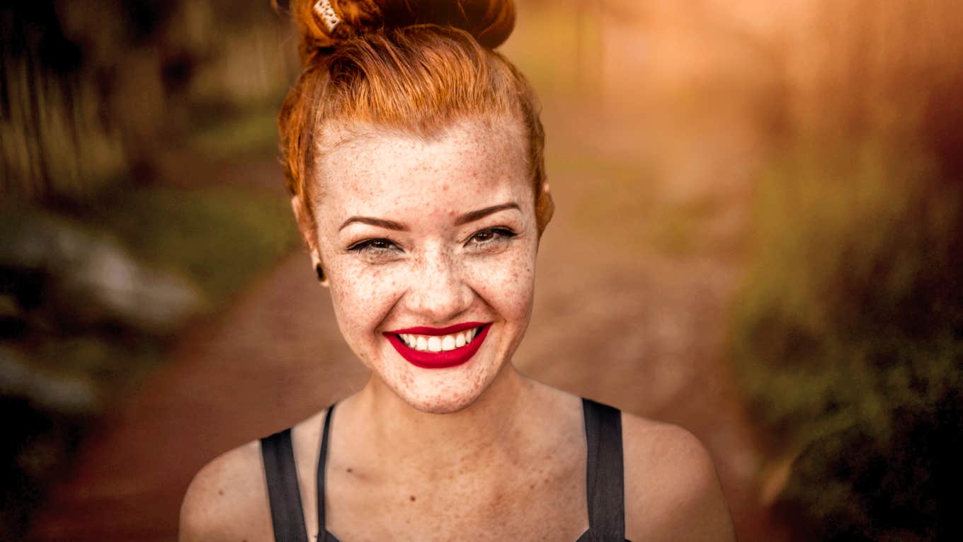 Secret Cheat Codes Every Woman Can Use To Get Ahead In Life Woman who is ahead in life, smiling.