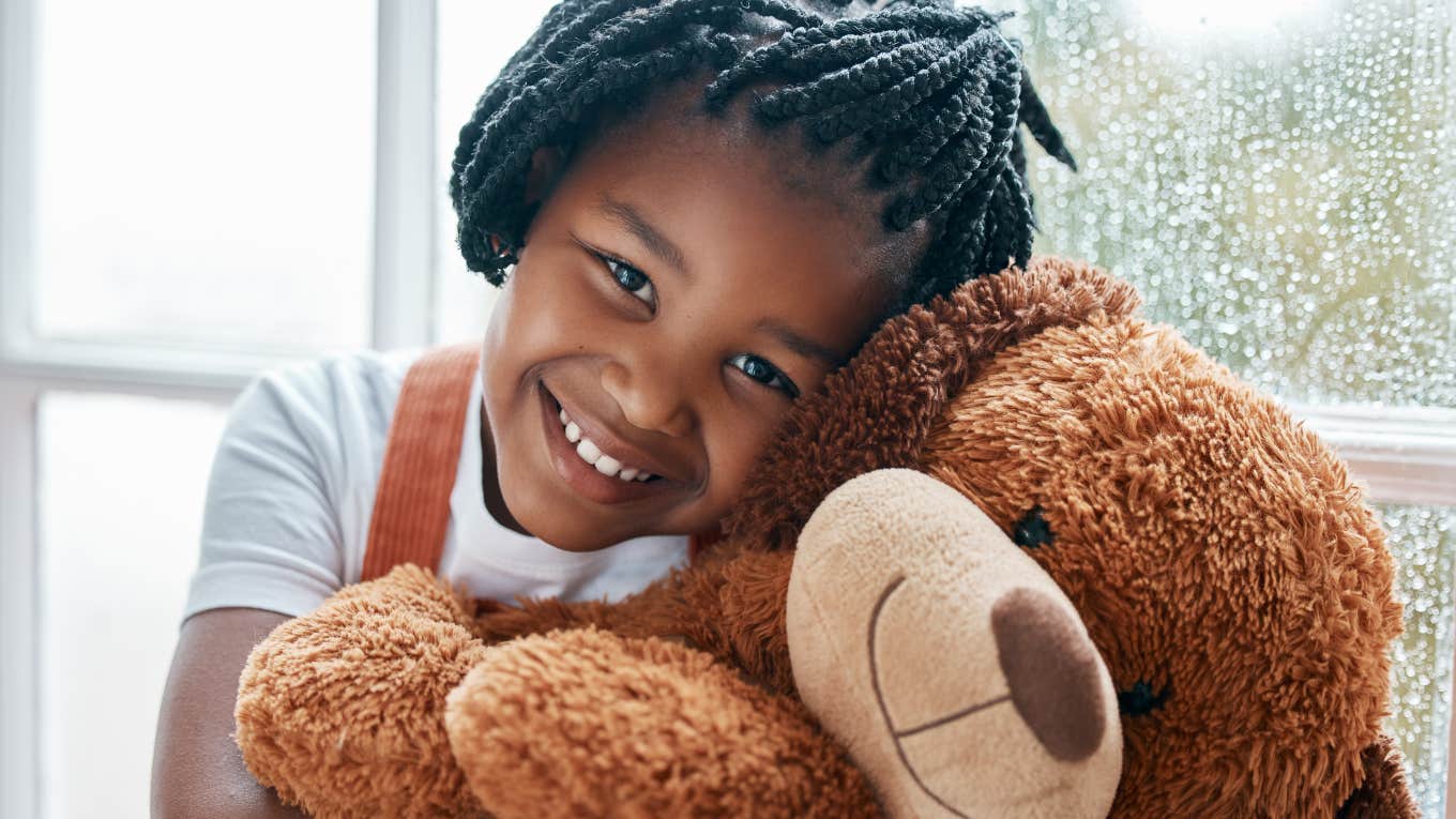 Stuffed Animal Adoption Agency 'Rehomes' Toys No Longer Wanted little girl hugging a large stuffed bear