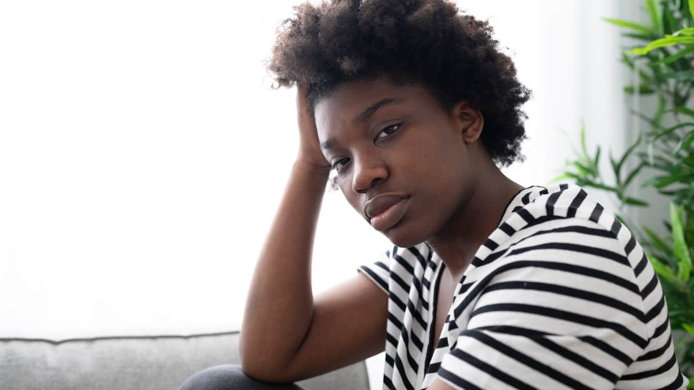 10 Invalidating Phrases That Alienate People, According To A Relationship Expert sad woman who's had her feelings invalidated
