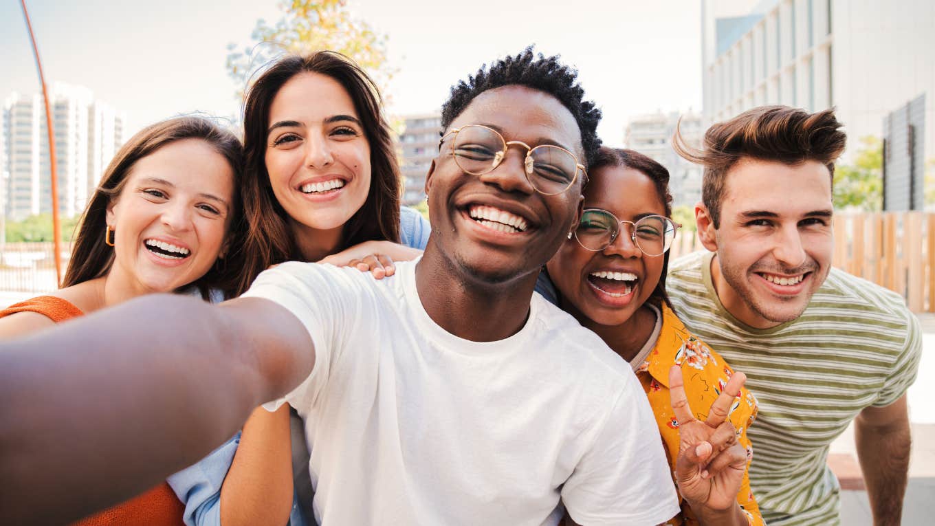 Rare Traits That Make Strangers Instantly Like You, According To Psychology group of strangers bonding