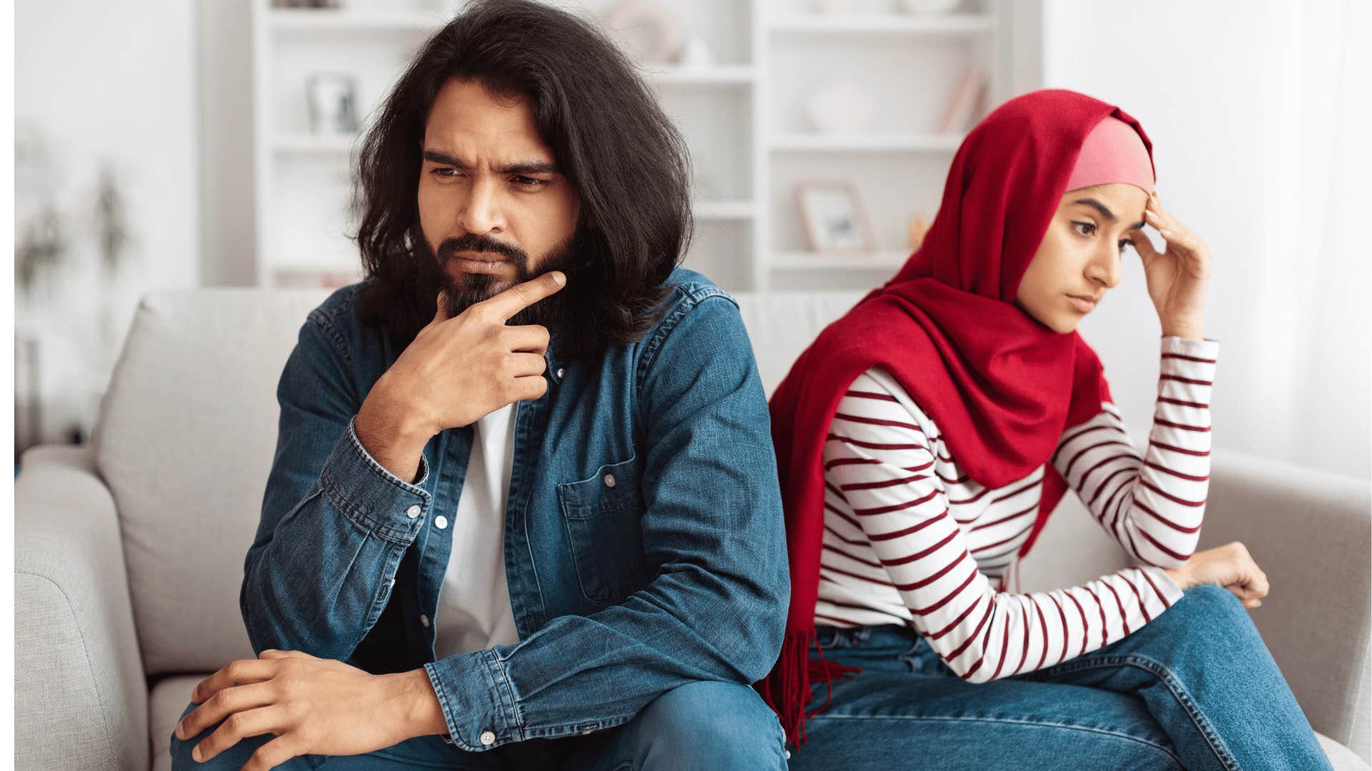 Unhappy couple sit in silence not looking at each other