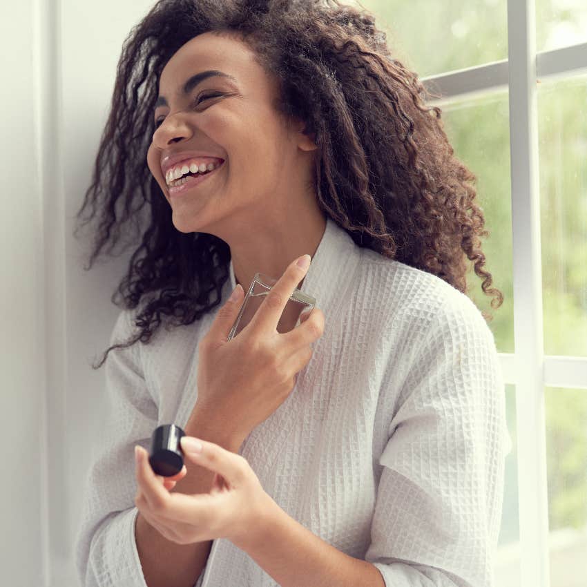 Woman using expensive perfume