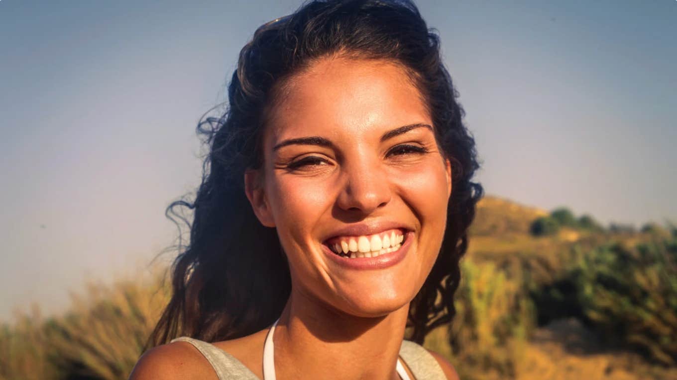 Factor that impacts behavior more than personality type via brain scientist Woman outdoors happy about what influences behavior more than personality type