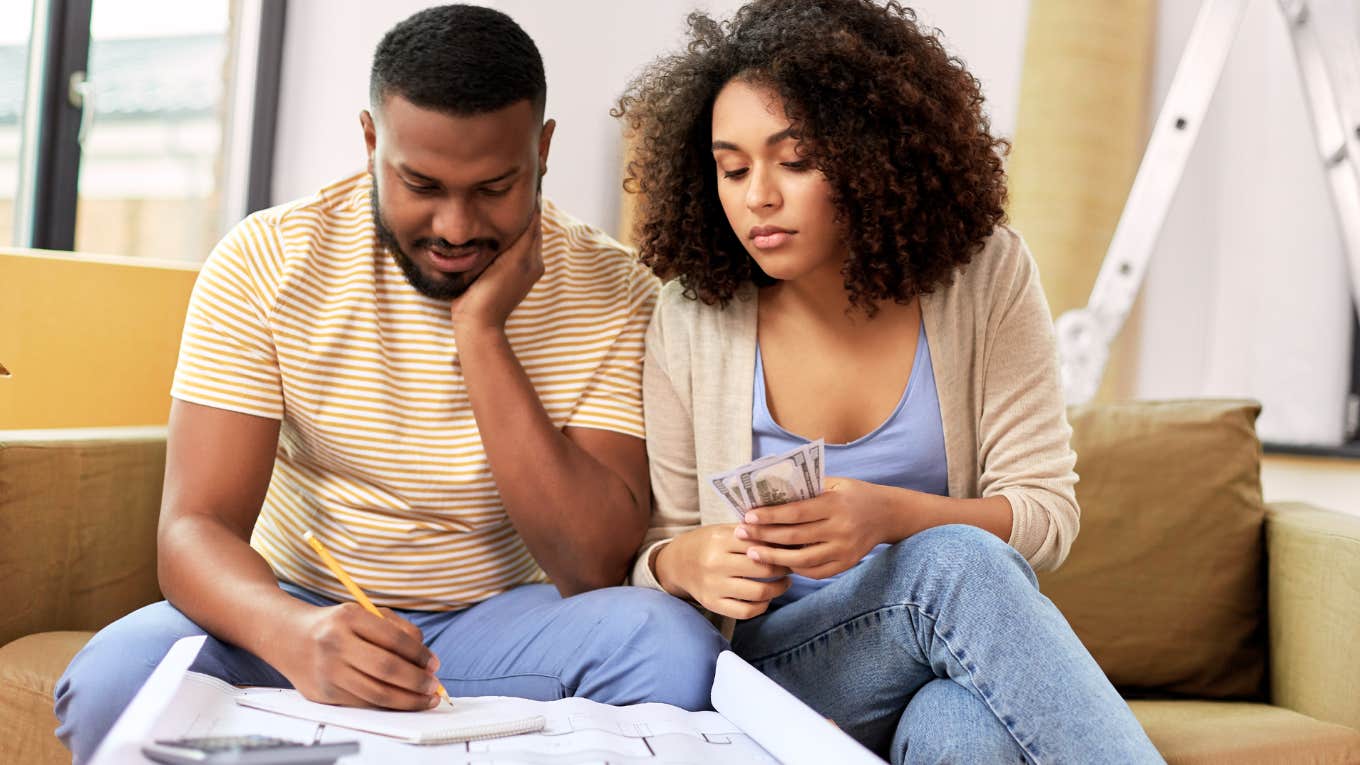 We Committed The Ultimate Newlywed Money Faux Paus Couple looking at their finances together.