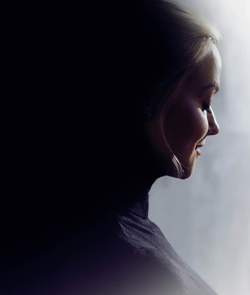 Woman with light in front and dark behind, pondering personality type and behavior