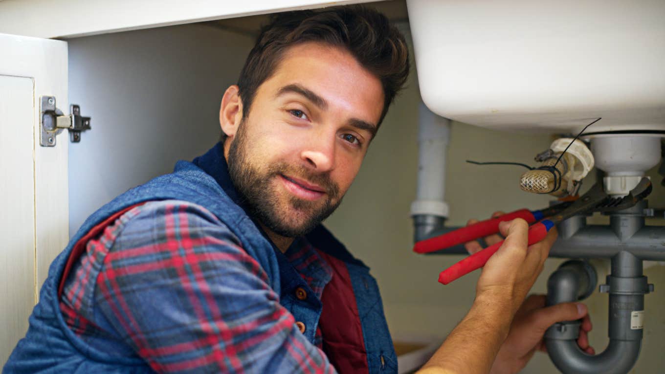 Farmer Cancels Plumbing Contract After Finding Out How The Plumber Voted Plumber working on sink