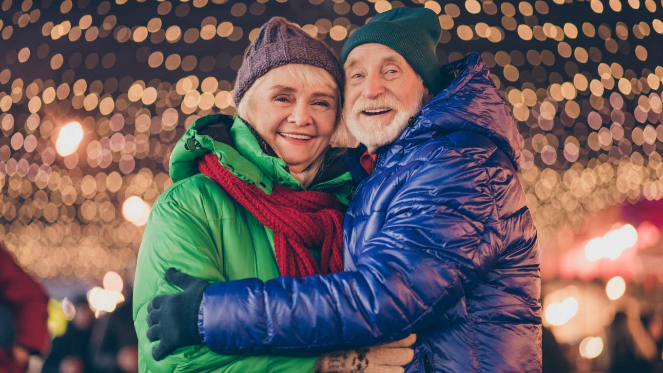 Husband Decorates Every House On His Block To Give His Wife A Lasting Christmas Memory After Her Diagnosis Senior couple in front of Christmas lights