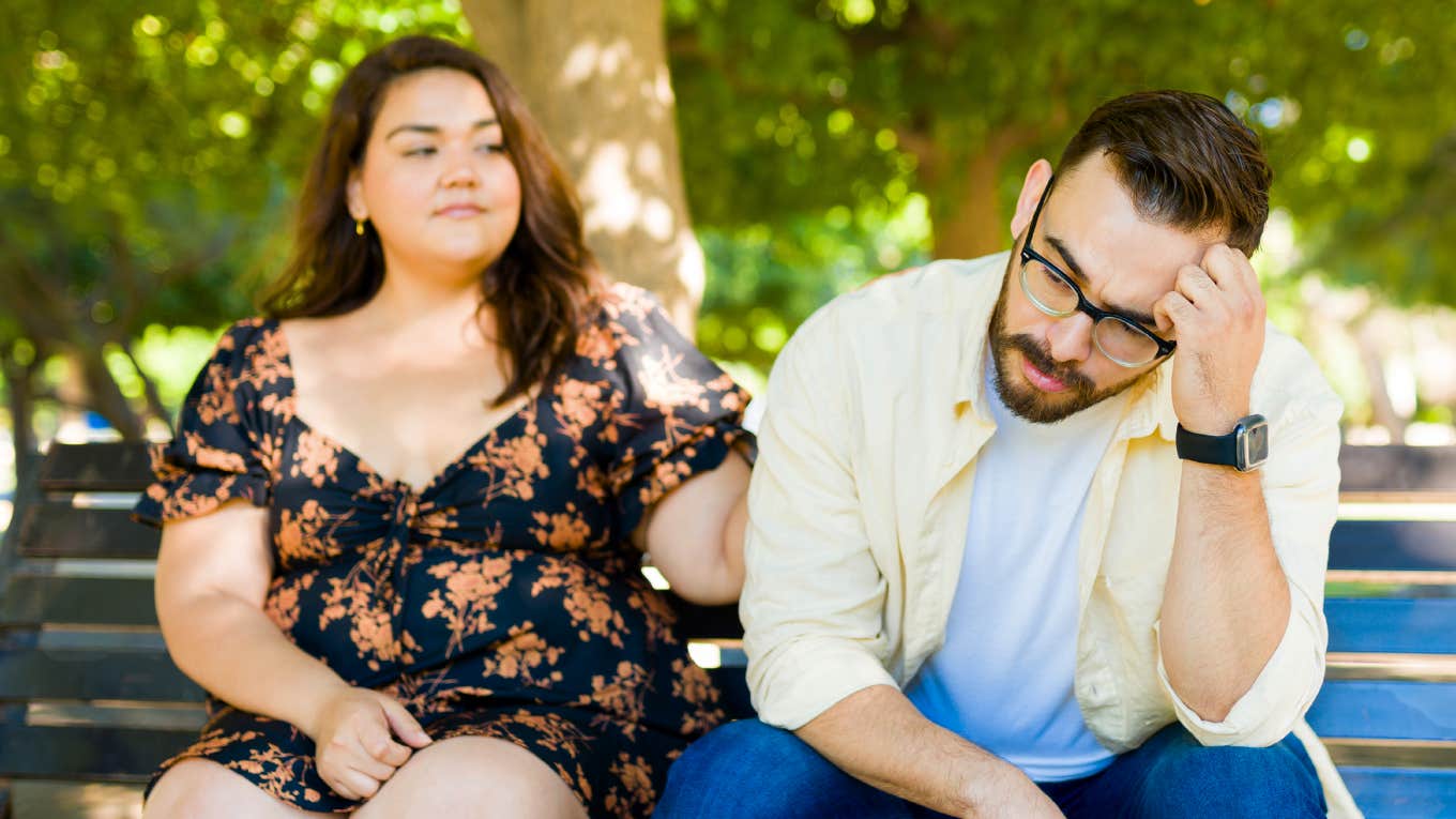 There's One 'Lazy' Word That Derails Great Marriages And Everyone Uses It All The Time Couple lazily sitting on a bench.