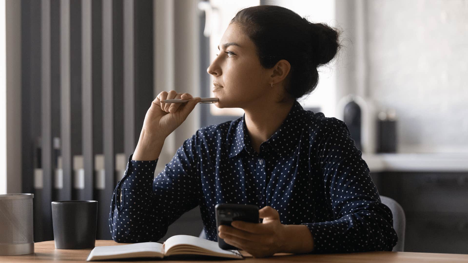 woman thinking deeply while staring off into space