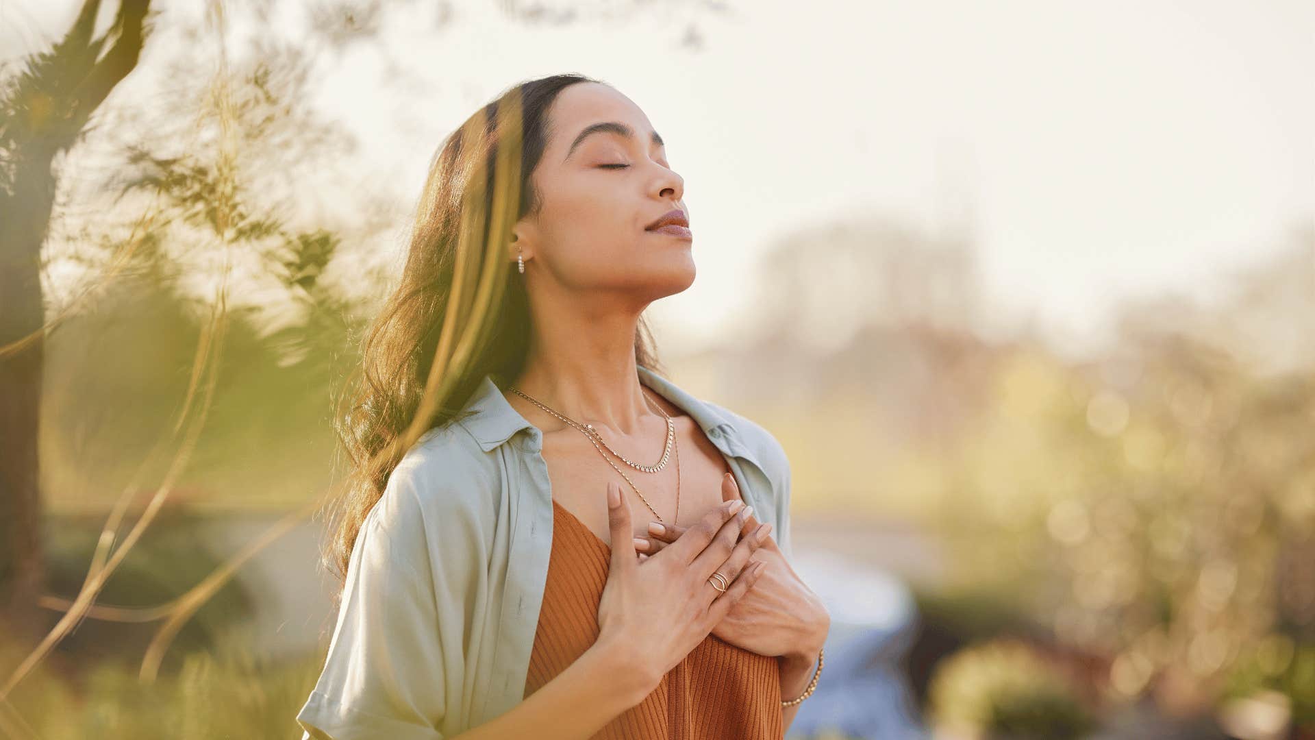 woman deep breathing outside 