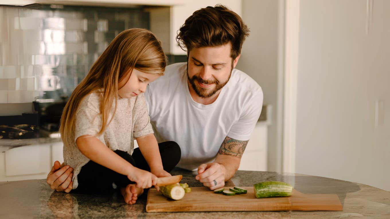 An old-fashioned thing millennial's refuse to do anymore in their relationships/marriages Stay at home millennial father, in the kitchen cooking with daughter while wife is at work.