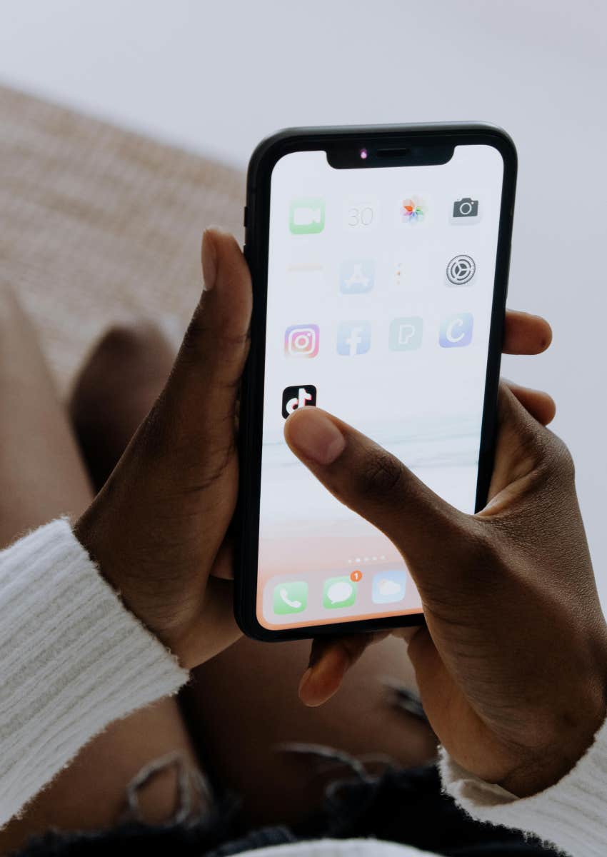 person opening TikTok app on phone