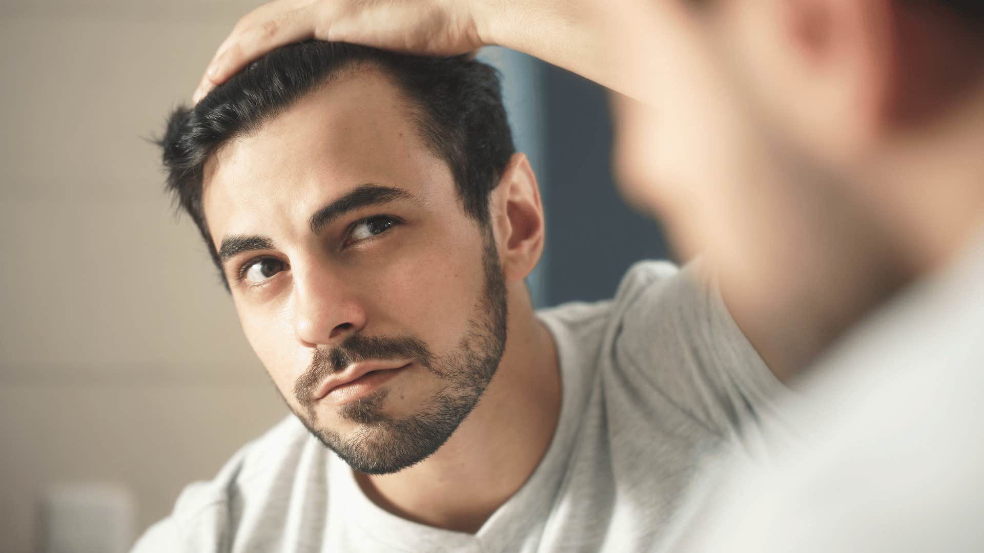 man looking at himself in mirror