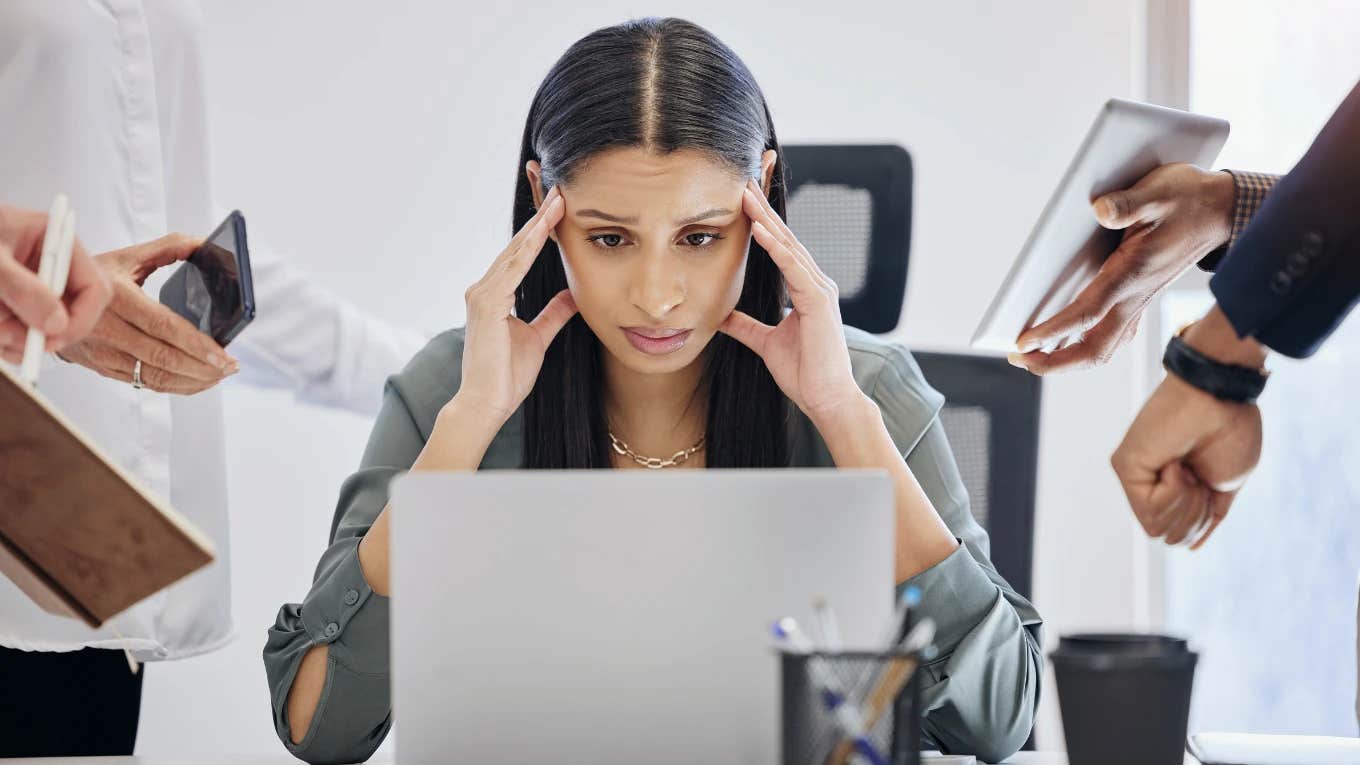 Signs You're Burned Out, According To A Psychologist Woman who is burned out at work