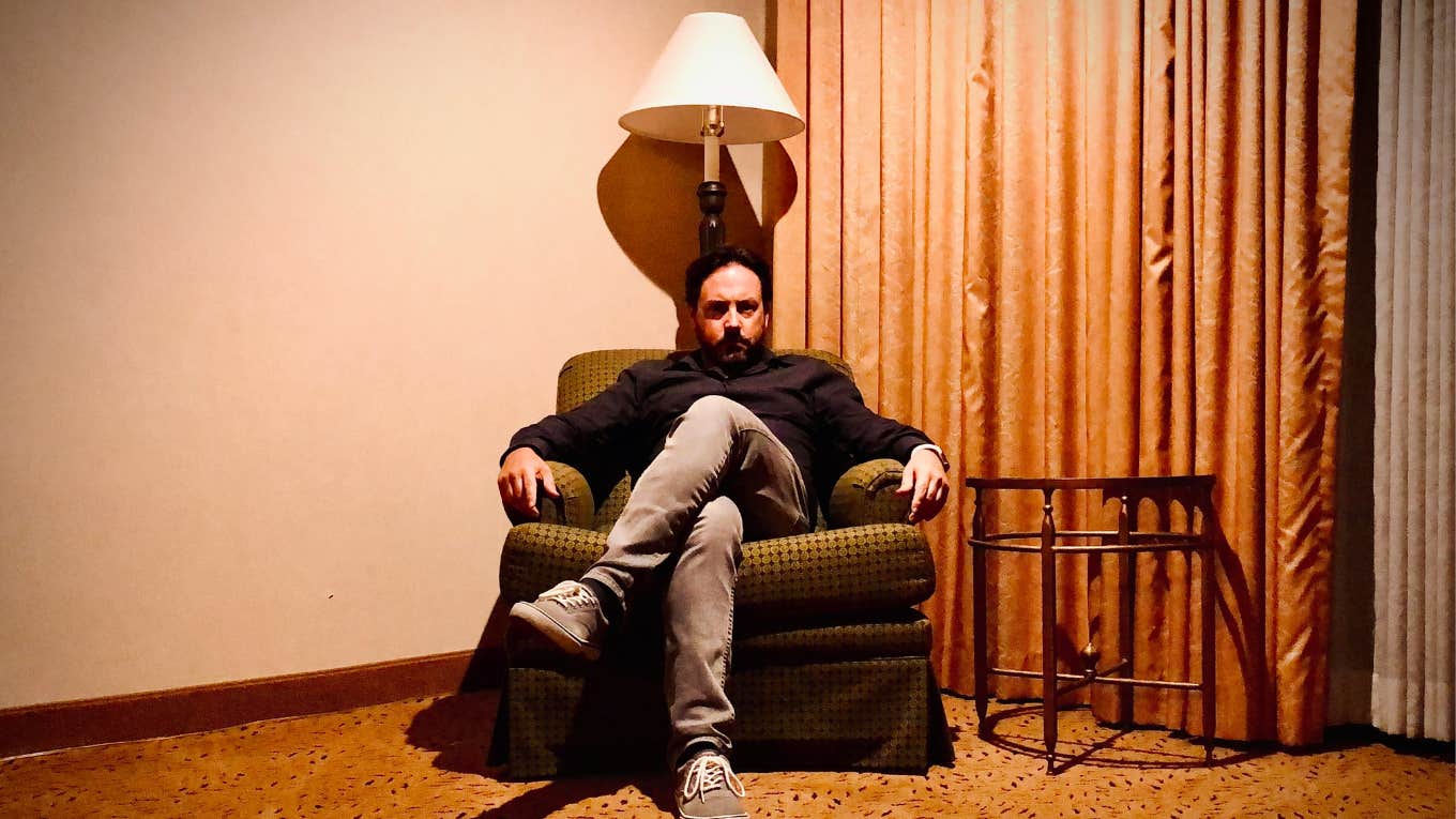 Odd Signs Someone You Love Is An Undercover Psychopath Man sitting in a eerie room, undercover psychopath.