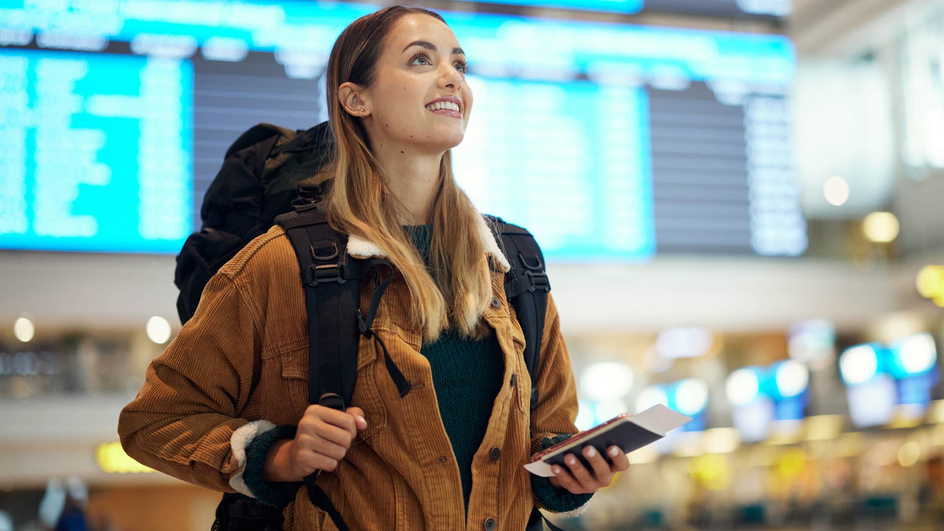 Woman smiling while walking in the airport.