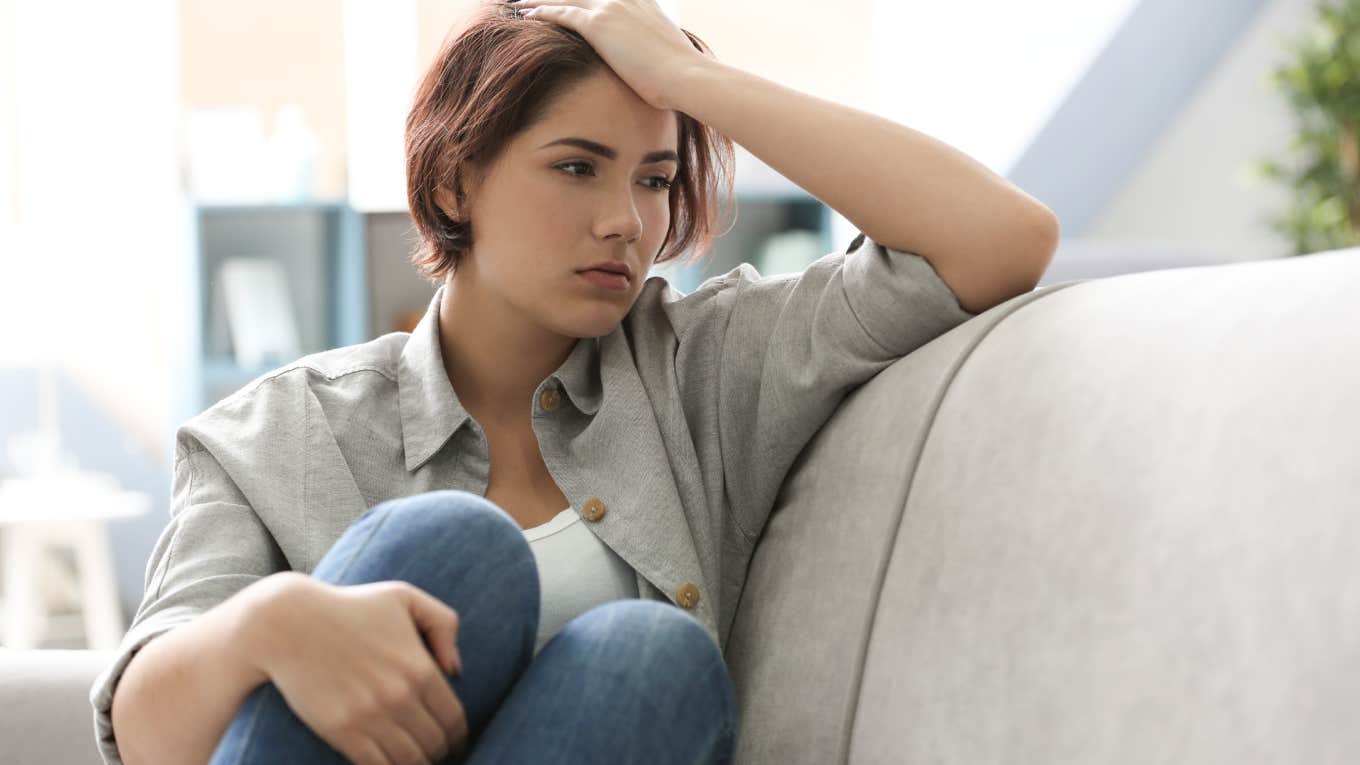 Woman Reveals The Unsettling Reason She Regrets Marrying For Money Depressed young woman sitting on sofa at home