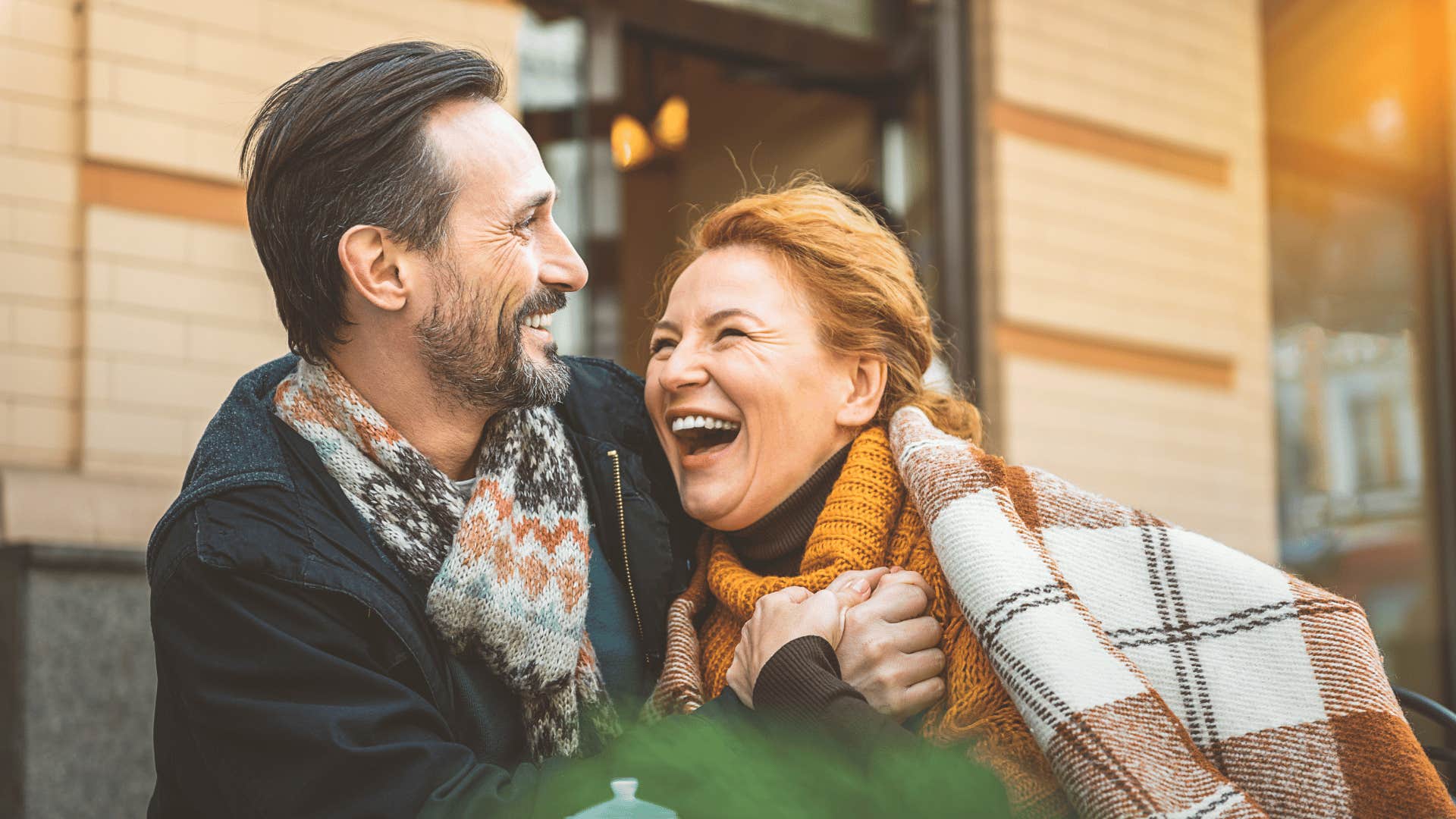 woman laughing while talking to man