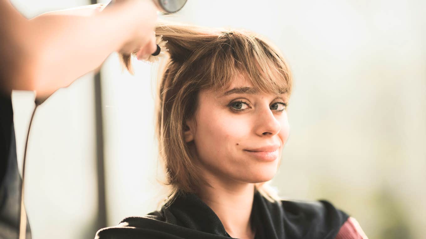 Hairstyles You'll See Everywhere In Twenty-Twenty Five, And The Best For Your Face Shape, According To Pros Woman getting a new hairstyle.