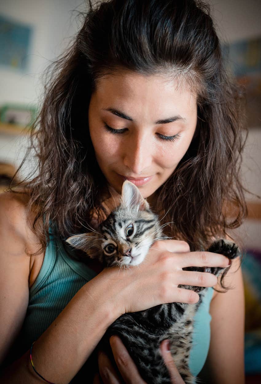 woman cuddling kitten avoid phrase hospice vet hates hearing people say as last words