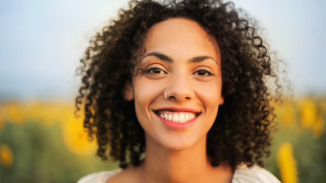 Neuroscientist Shares Tips To Stop Your Brain From Holding You Back From Achieving Your Goals Happy woman who achieved her goals