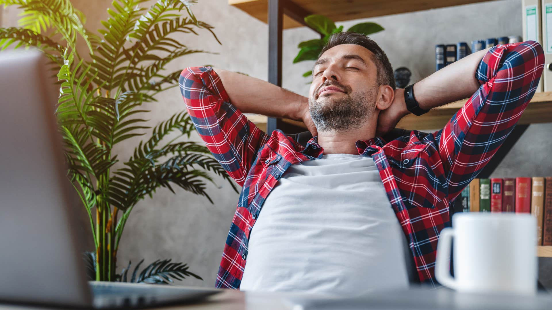 Man relaxing at his work desk. 