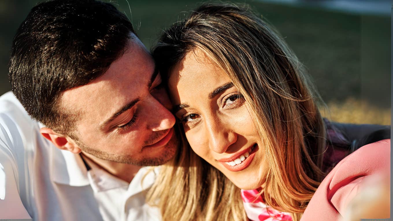 Subtle Ways A Man Reveals How He Feels About Someone, According To Psychology Man loving on woman, partner.