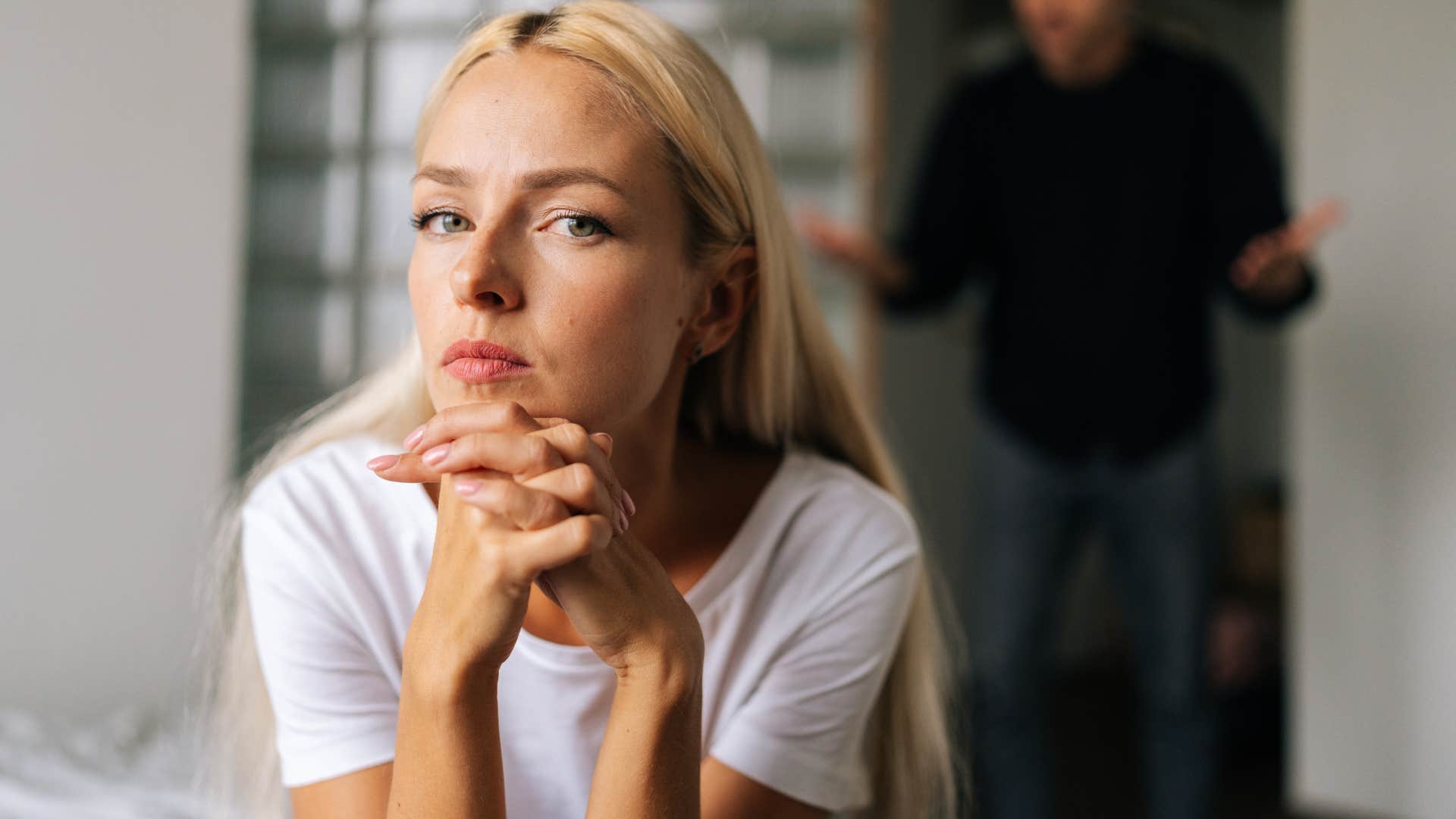 Upset woman turned away from her partner