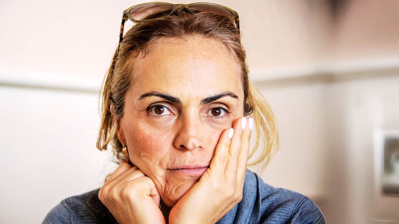 It Took Me Way Too Long To Move On From My Divorce, Due To These Mistakes Woman post divorce, staring out blankly